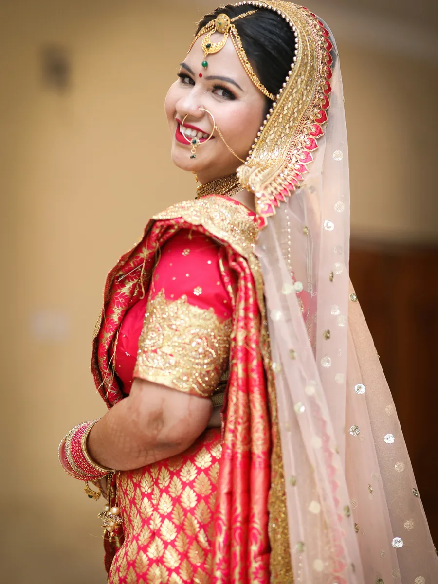 Woman dressed in elegant red and gold festive Indian wear